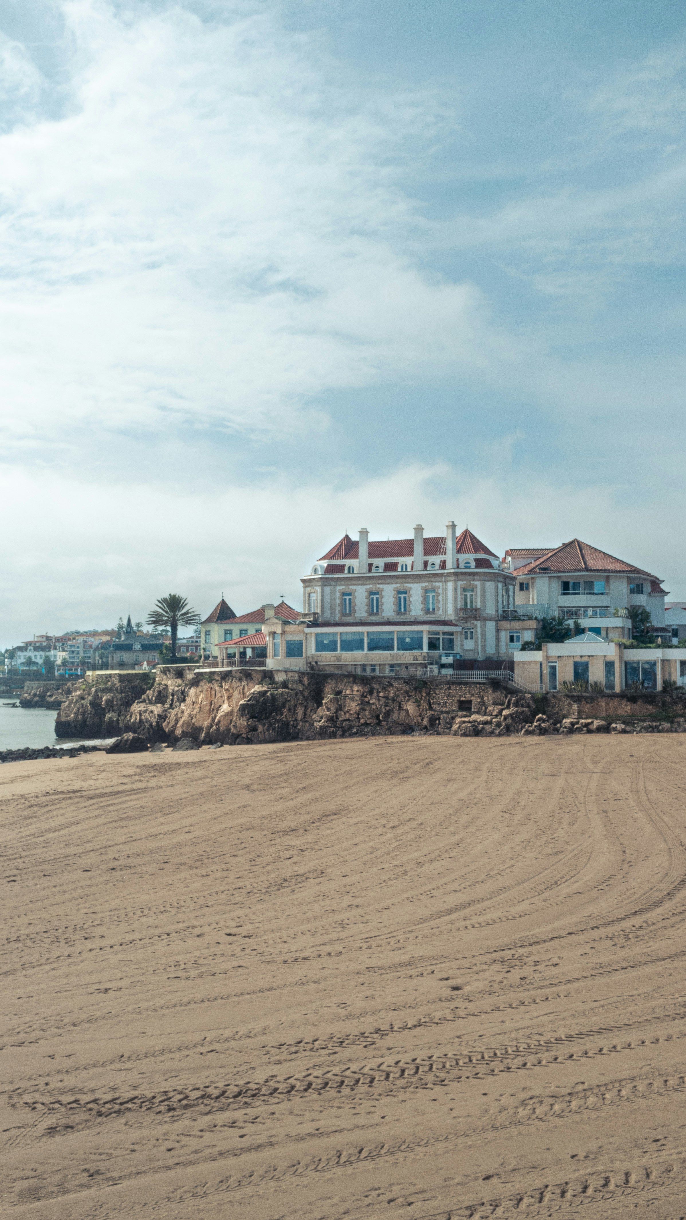 concrete buildings by the beach during daytime